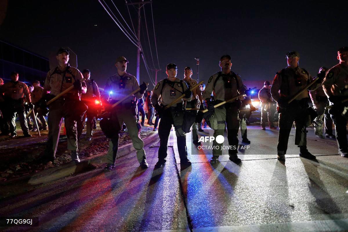 Illinois State Police stand guard while monitoring protesters gathering near an Immigration and Customs Enforcement (ICE) facility in Broadview, Illinois, on October 4, 2025. - AFP