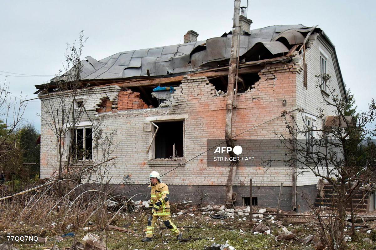 A Ukrainian rescuer walks in the courtyard of a destroyed house following an air attack in Lapaivka, Lviv region on October 5, 2025, amid the Russian invasion of Ukraine. (Photo by STRINGER / AFP)