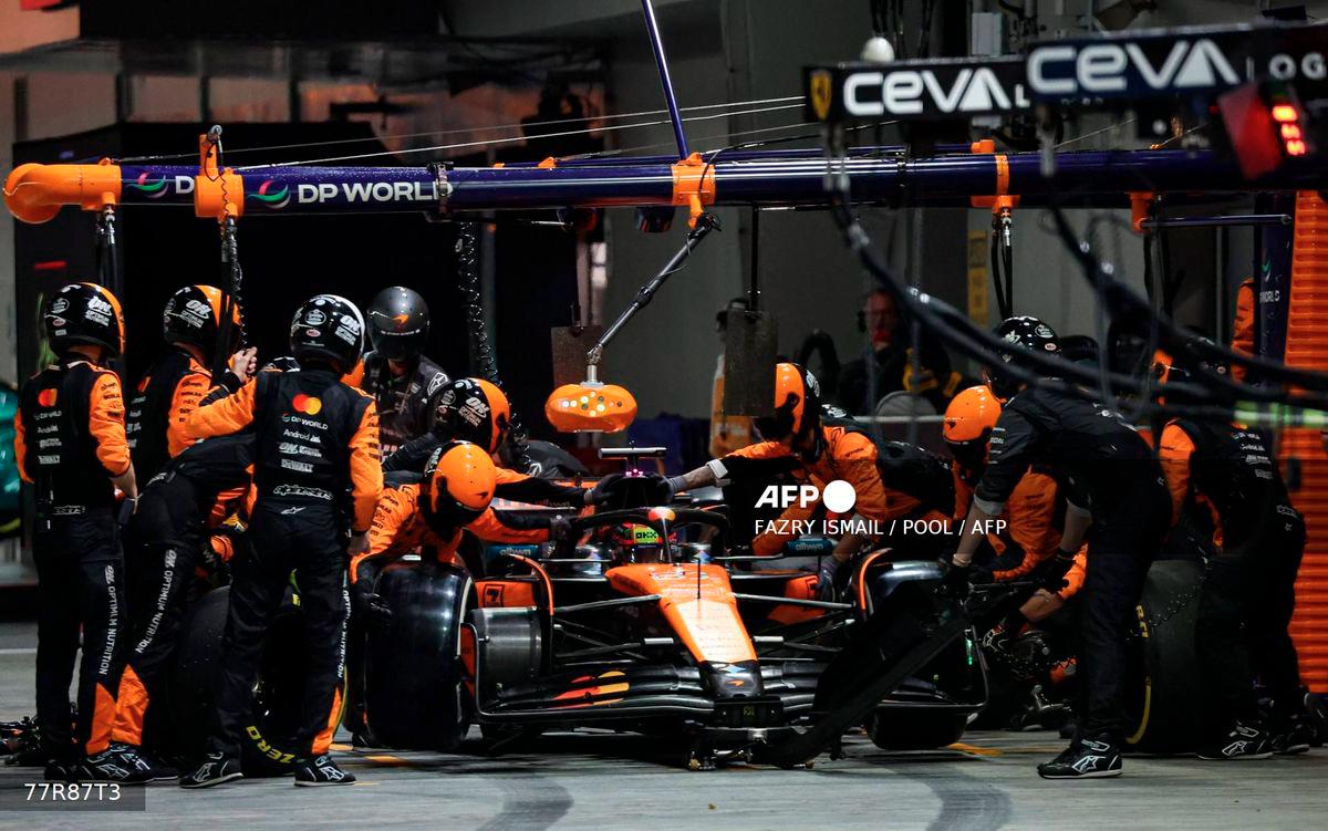 McLaren's Australian driver Oscar Piastri makes a pit stop during during the Formula One Singapore Grand Prix night race at the Marina Bay Street Circuit in Singapore on October 5, 2025. - POOL via AFP