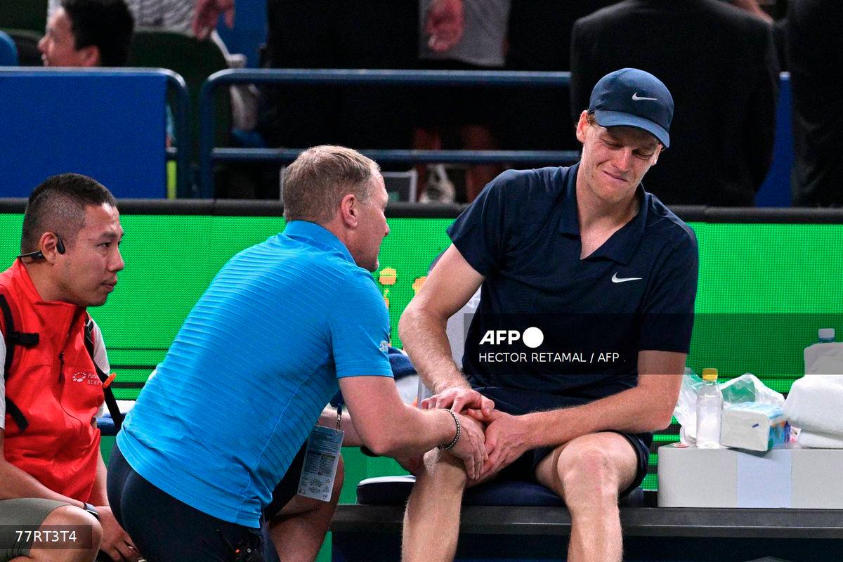 Italy's Jannik Sinner (R) reacts on the bench as he receives medical attention during his men's singles match against Netherlands' Tallon Griekspoor at the Shanghai Masters tennis tournament in Shanghai on October 6, 2025. - AFP