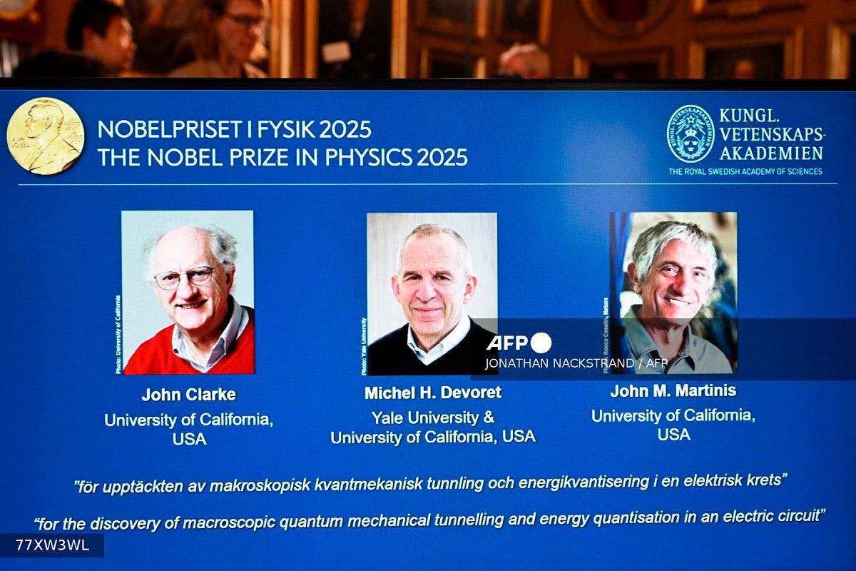 Photos of (LtoR) British physicist John Clarke at the University of California, USA, French physicist Michel H Devoret (University of California and Yale) and US physicist John M Martinis (University of California) are seen on a screen during a press conference on the awarding of the 2025 Nobel Prize in Physics at the Royal Swedish Academy of Sciences in Stockholm, Sweden, on October 7, 2025. - Jonathan Nackstrand / AFP
