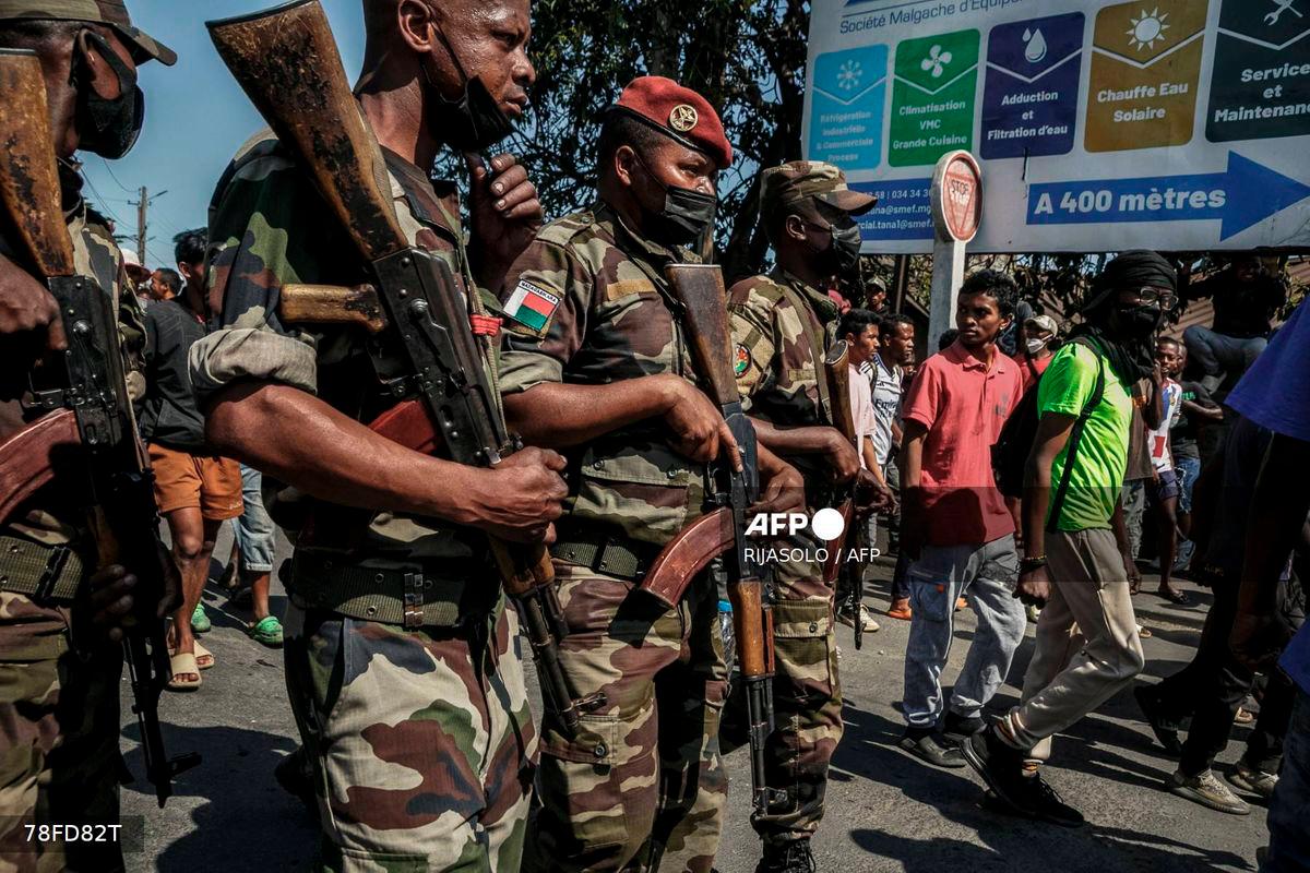 Members of a Madagascar army contingent stand in a road near their camp near Antananarivo on October 11, 2025. - AFP