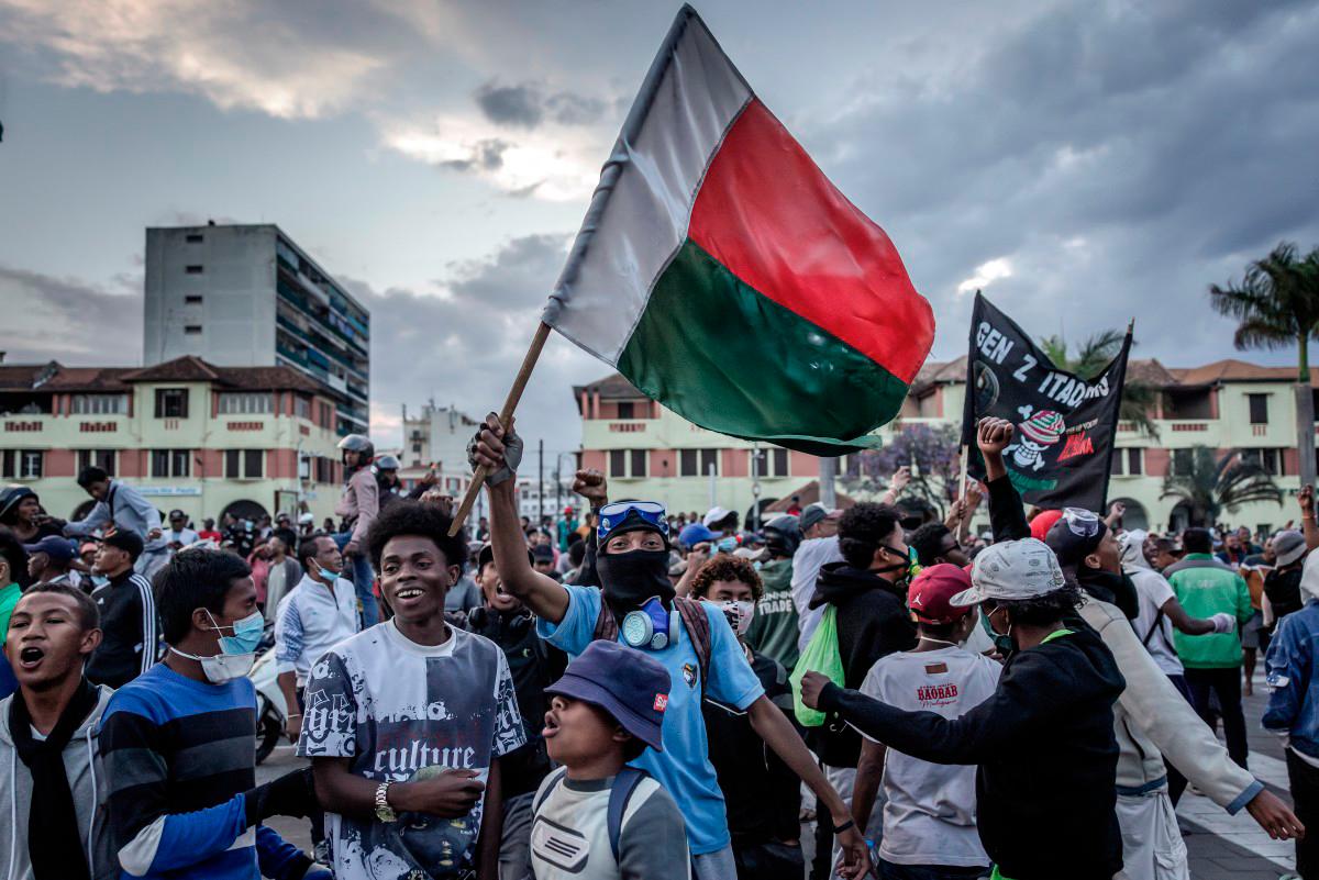 Protesters celebrate at Antananarivo City Hall after listening the address of members of a section of the Malagasy army following clashes between demonstrators and security forces during protests calling for the resignation of President Andry Rajoelina in Antananarivo, on October 11, 2025. - AFP