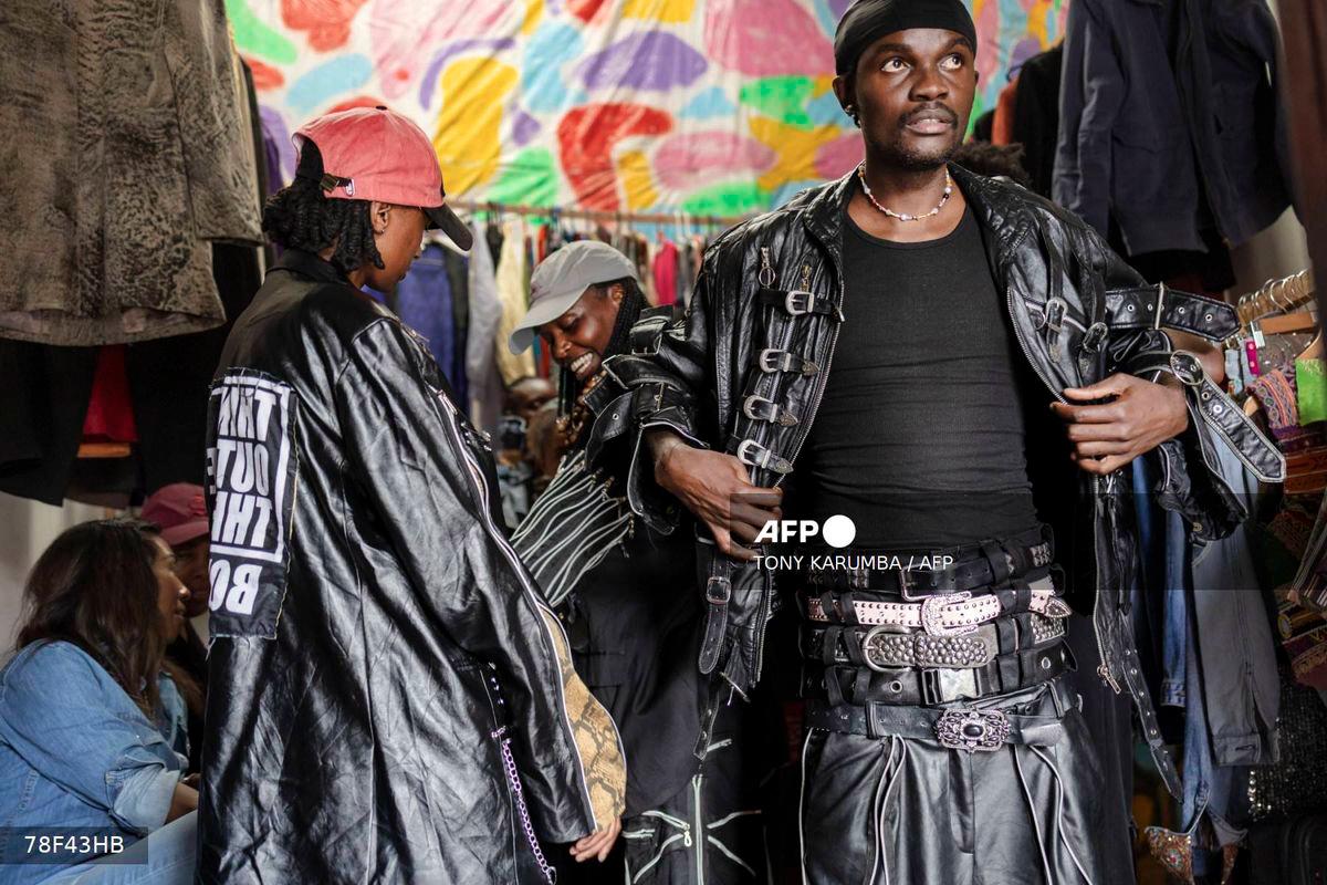 Models fit designs by kenyan fashion designer Morgan Azedy, a rising star among designers specialising in upcycling discarded fabrics and garments prior to a fashion show of various local designers dubbed 'Wasteland Gikomba fashion' in Nairobi on October 9, 2025. - AFP
