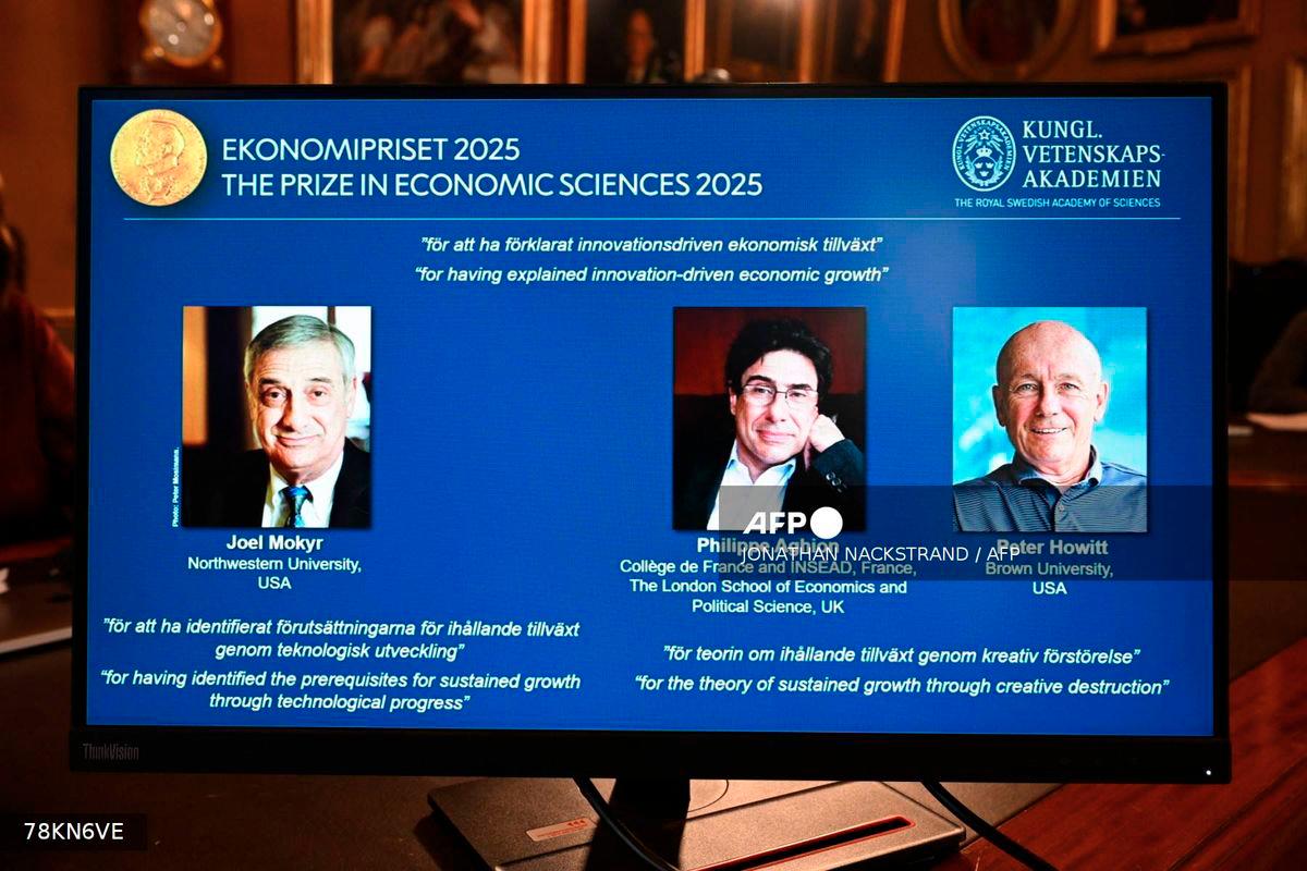 A screen displays the portraits of the 2025 prize winners (L-R) Joel Mokyr, Philippe Aghion and Peter Howitt, during the announcement of the winners of the 2025 Nobel Prize in Economics, the Sveriges Riksbank Prize in Economic Sciences in Memory of Alfred Nobel, at the Royal Swedish Academy of Sciences in Stockholm, Sweden, on October 13, 2025. - AFP