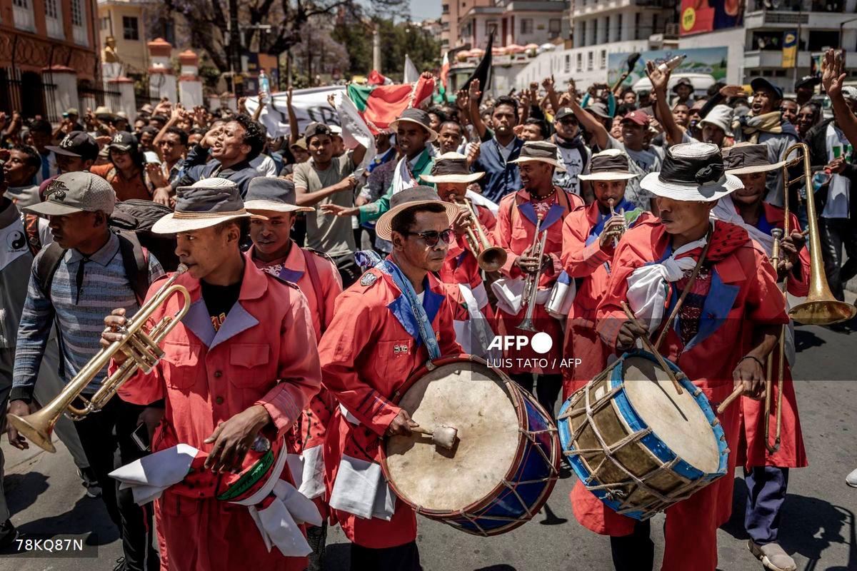 Members of a band play music as students dance and march in celebration toward a civil society rally in Antananarivo, on October 13, 2025. Soldiers and security forces joined hundreds celebrating in Madagascar's capital on October 13, 2025, hours before President Andry Rajoelina was due to address the nation following weeks of protests and growing calls for his resignation. - AFP