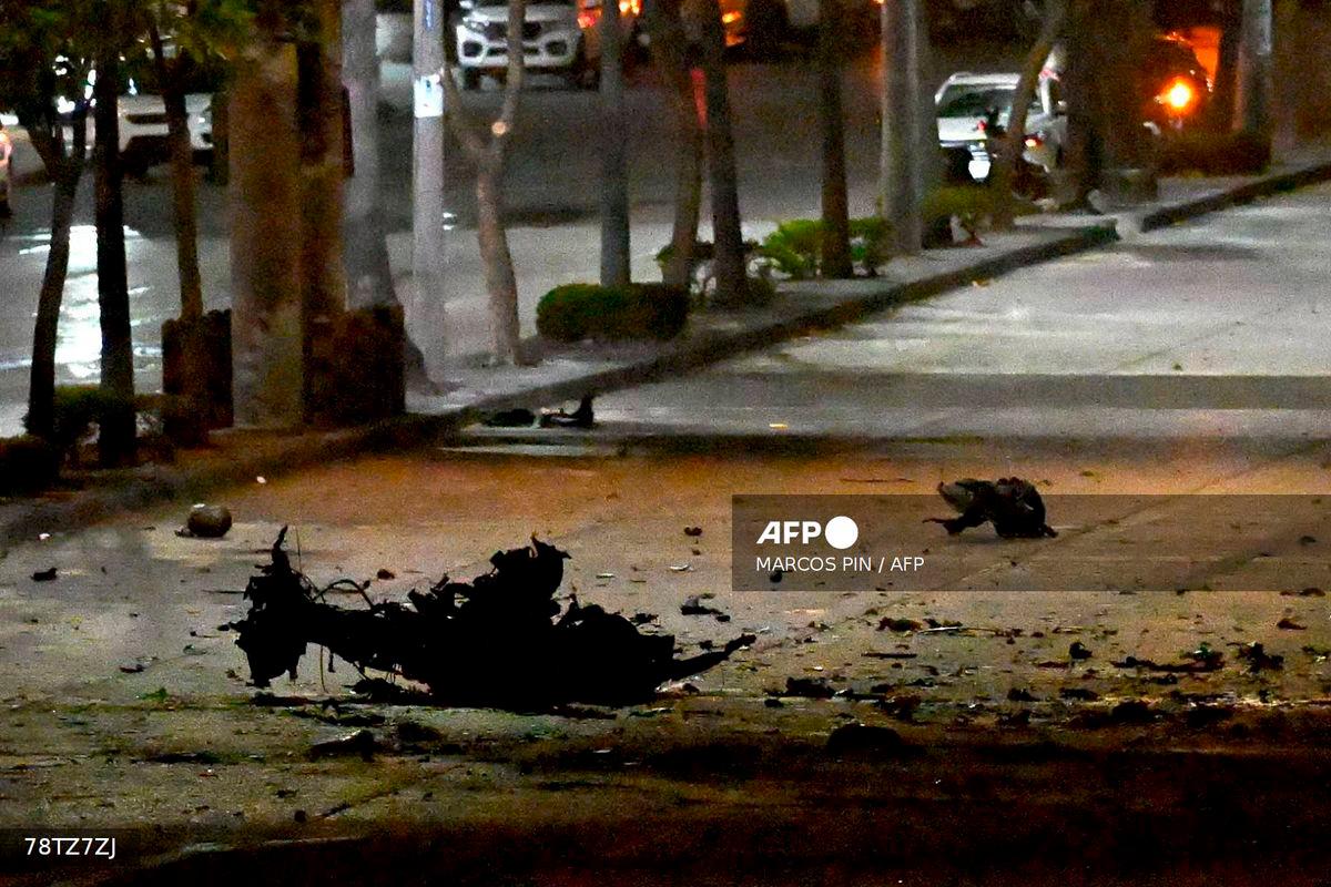The remains of a suspected car bomb that exploded in front of a shopping center are pictured in the north of Guayaquil, Ecuador on October 14, 2025. Photo by MARCOS PIN / AFP
