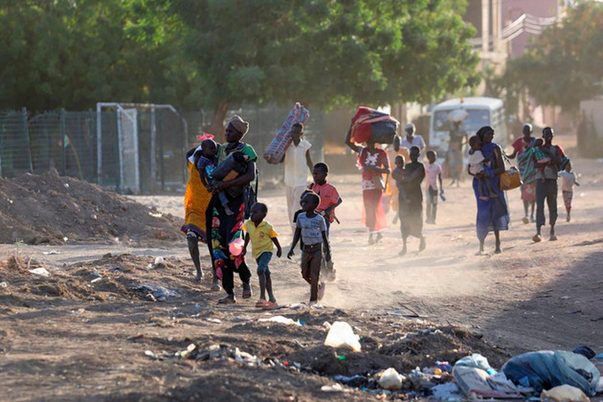 People flee amid fighting between the army and paramilitaries in Khartoum, Sudan, on April 19, 2023. The U.N. estimates that more than 4.8 million people have been displaced internally in Sudan and 1.2 million have fled to neighboring countries since April. | AFP/Getty Images