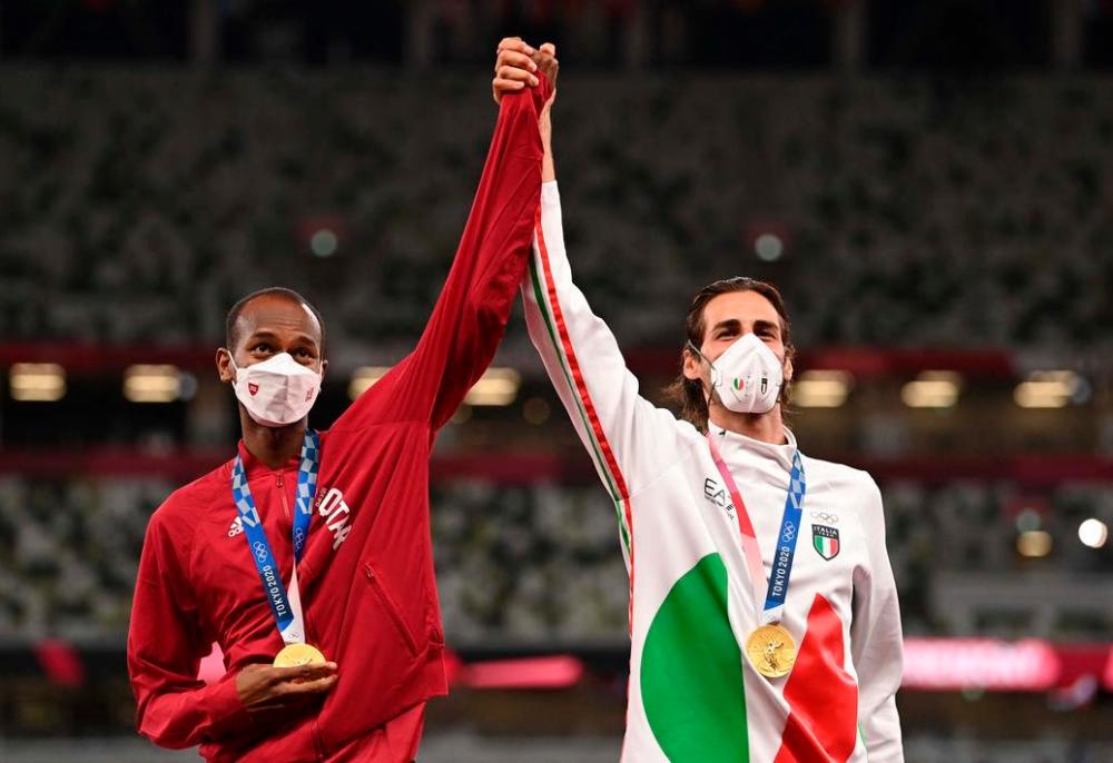 Qatar’s Mutaz Essa Barshim and Italy’s Gianmarco Tamberi sharing the top spot on the podium for the men’s high jump at the 2020 Tokyo Olympic Games. – AFP