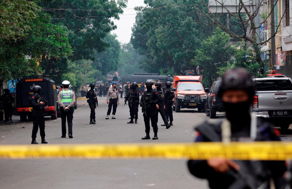 Armed police officers stand guard following a blast at a district police station, that according to authorities was a suspected suicide bombing, in Bandung, West Java province, Indonesia, December 7, 2022. REUTERSPIX