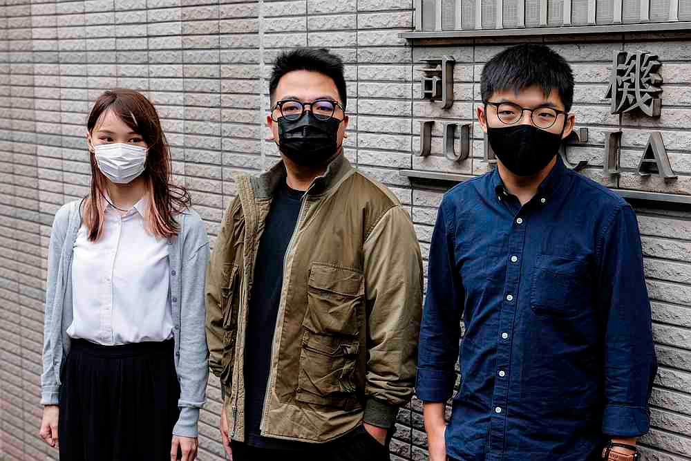 Pro-democracy activists (from left) Agnes Chow, Ivan Lam and Joshua Wong and arrive at the West Kowloon Magistrates’ Courts in Hong Kong November 23, 2020. —— Reuters