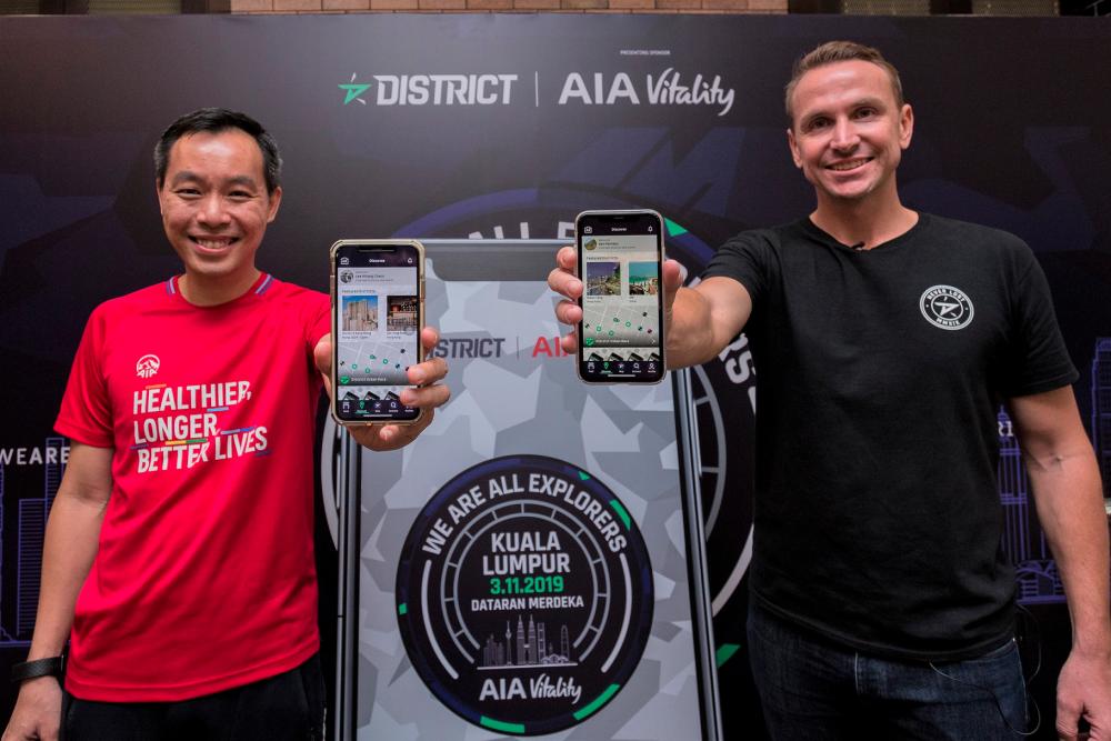 From left: Heng and Pember launching the District Race app in Malaysia.