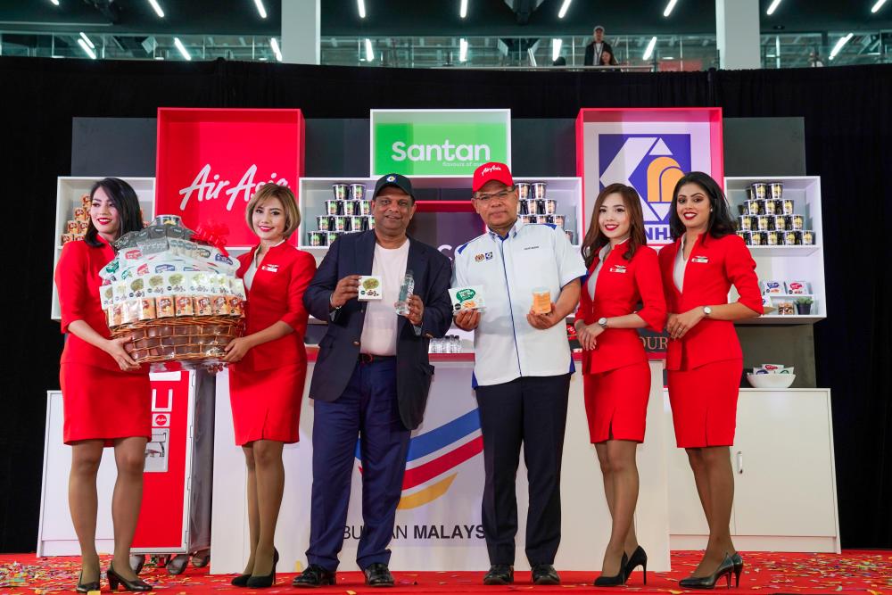 Fernandes and Saifuddin with some of the products sold onboard AirAsia flights.