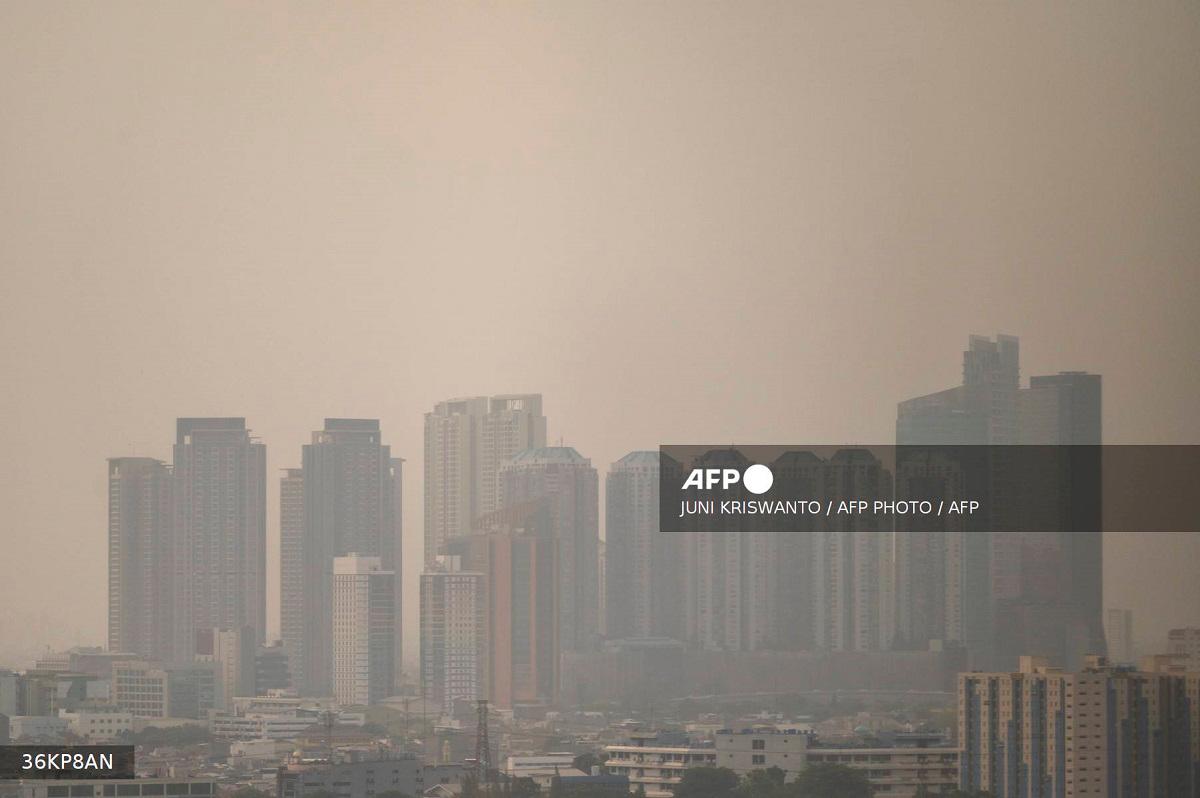 Skyscrapers are seen shrouded by polluted air in Jakarta on October 23, 2024. - JUNI KRISWANTO / AFP