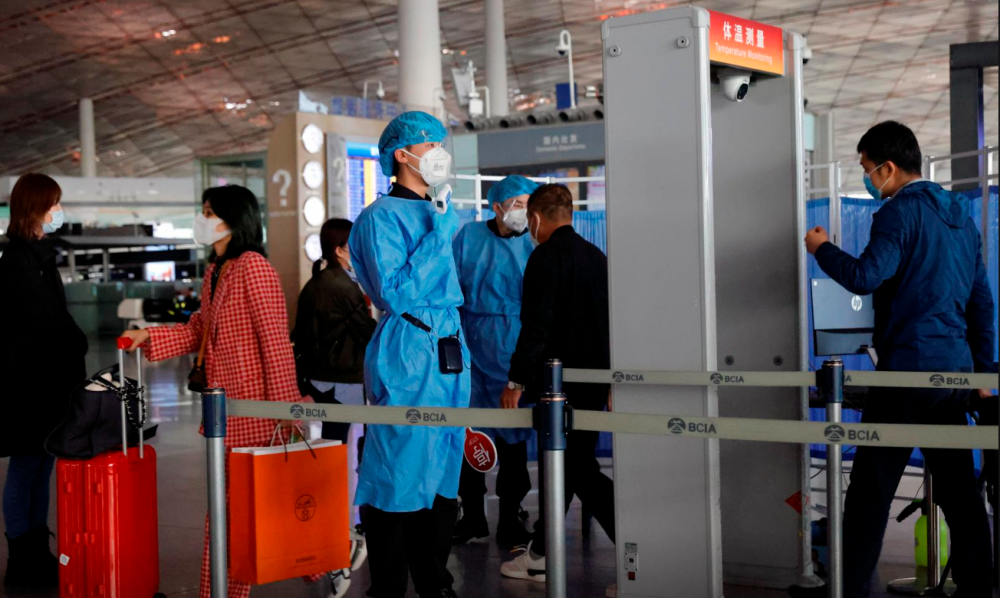 File photo: Medical staff members check the temperature of people as they enter at Capital Airport, following an outbreak of the coronavirus disease (Covid-19), in Beijing, China, November 5, 2020. REUTERSpix