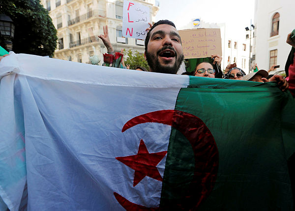 Students take part in a protest to denounce an offer by President Abdelaziz Bouteflika to run in elections next month but not to serve a full term if re-elected, in Algiers — Reuters