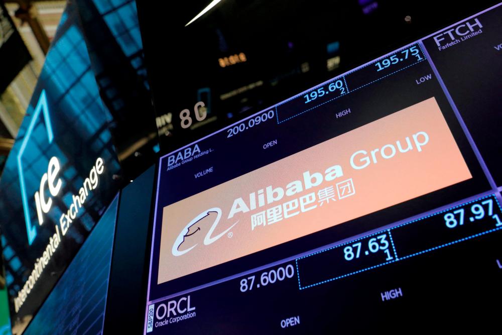 The logo of Alibaba Group is seen on the trading floor at the New York Stock Exchange. Alibaba says it will work to maintain its New York Stock Exchange listing alongside its Hong Kong listing – Reuterspix