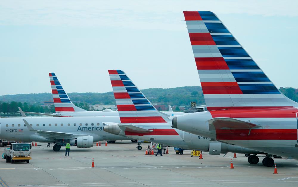 American Airlines jetlines sit at gates at Washington’s Reagan National airport. – REUTERSPIX
