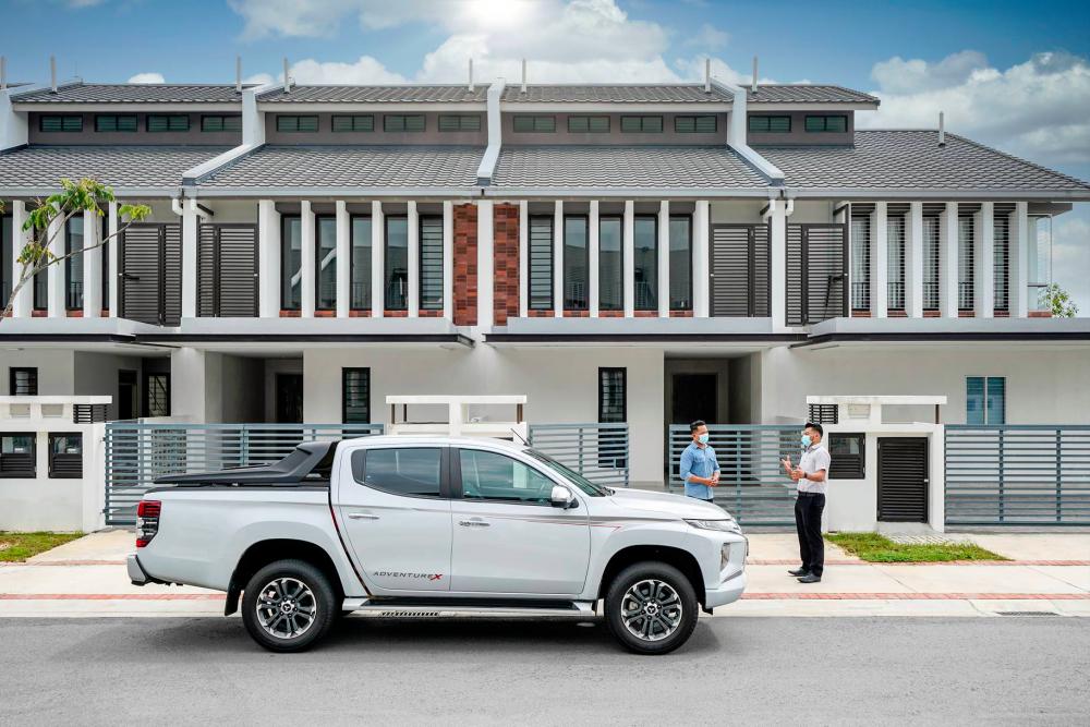An authorised MMM sales consultant delivering a Mitsubishi test drive car to a customer.
