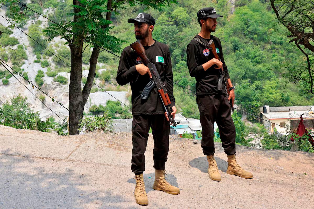 Police officers stand guard on a road leading to Bilal Mosque after it was hit by an Indian strike in Muzaffarabad, the capital of Pakistan-administered Kashmir - REUTERSpix