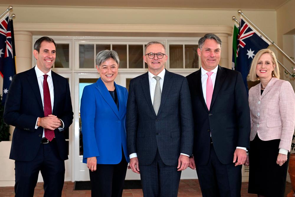 Australia's new Prime Minister Anthony Albanese (C) poses for pictures with his new cabinet ministers, Jim Chalmers (L), Penny Wong (2nd L), Richard Marles and Katy Gallagher (R) after the oath taking ceremony at Government House in Canberra on May 23, 2022. AFPpix