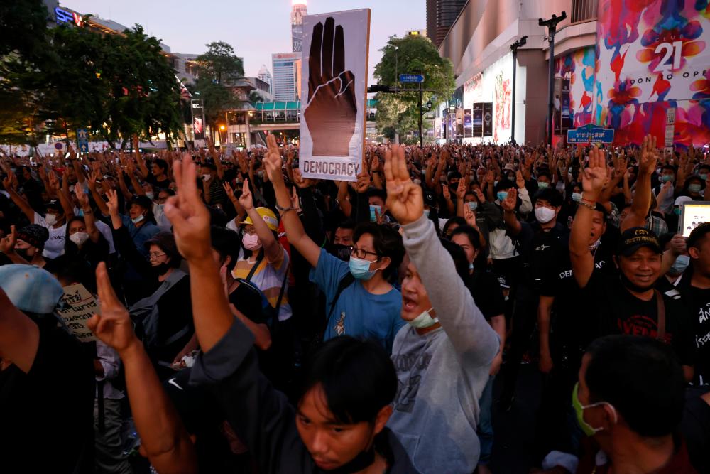Pro-democracy protesters make a three-finger salute during an anti-government protest in Bangkok, Thailand October 25, 2020. — Reuters