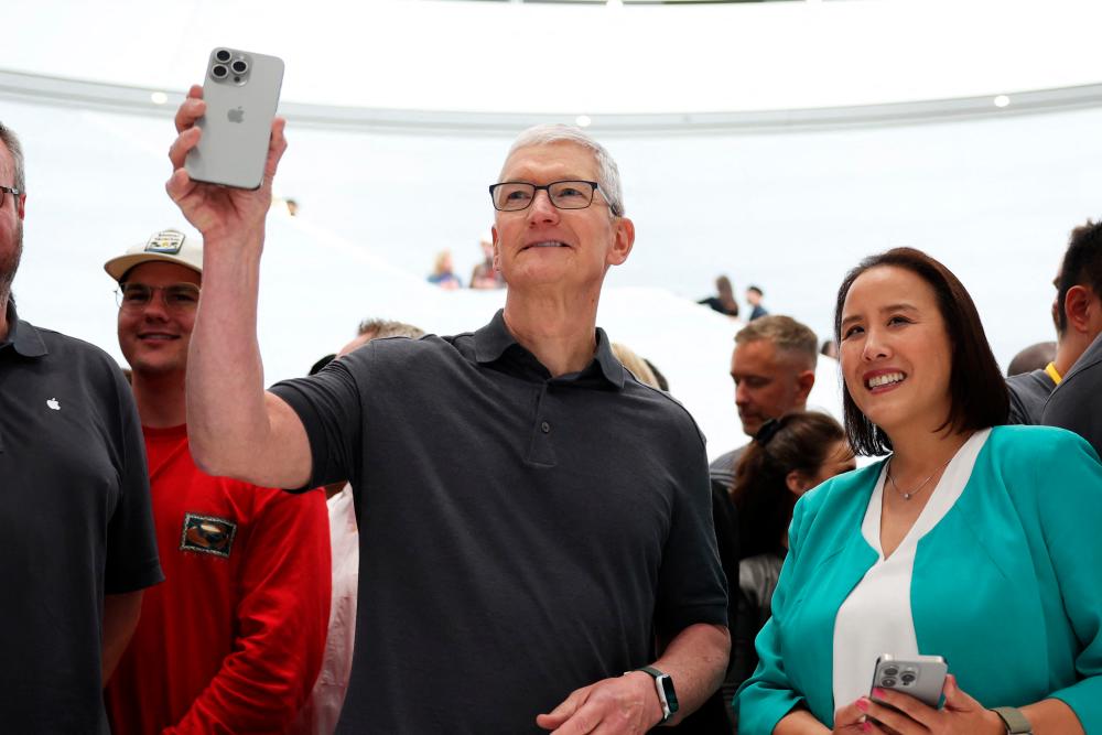 Apple CEO Tim Cook holds up a new iPhone 15 Pro during an Apple event on Tuesday, Sept 12, 2023 in Cupertino, California. – AFPpic