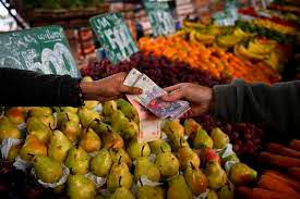 A customer buys fruits and vegetables at the central market in Buenos Aires. Soaring prices are forcing hard-hit shoppers to run a daily gauntlet to find deals and cheaper options. – AFPpic