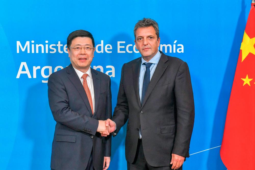 Handout photo released by the Argentine Economy Ministry shows Massa and Zou after signing an agreement to activate the swap between Argentina and China in Buenos Aires on Wednesday, April 26, 2023. – Handout/AFPpic