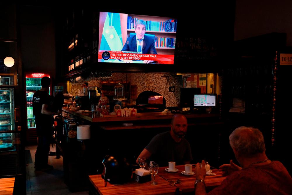 Caputo is seen on TV during an announcement of the new economic measures in Buenos Aires, on Tuesday. – AFPpic