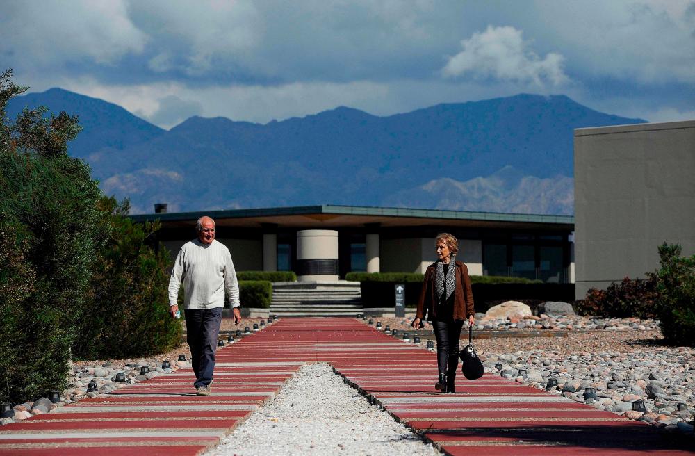Architects Mario Yanzon (L) and Eliana Bormida walk posing for a picture at Alfa Crux, a winery in the Uco Valley, San Carlos Department, in the Argentine province of Mendoza, on April 1, 2021. –AFP