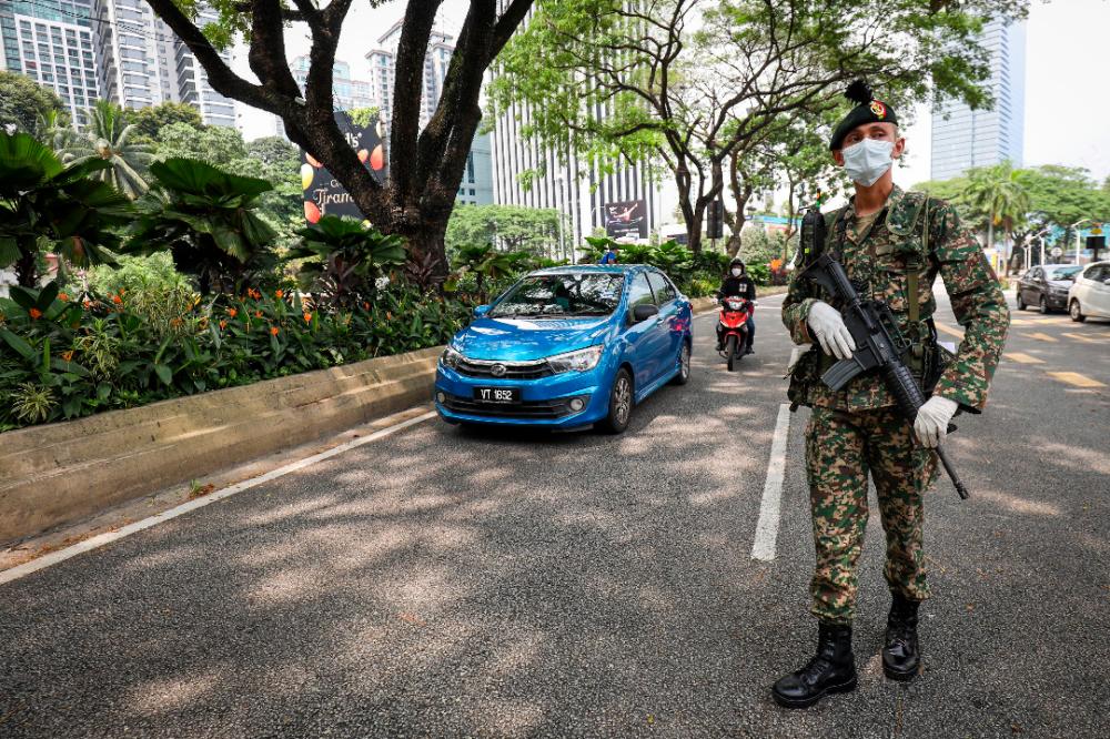 An officer from the Malaysian Armed Forces, during a roadblock, at the city centre, on March 22, 2020. — Sunpix by Hafiz Sohaimi