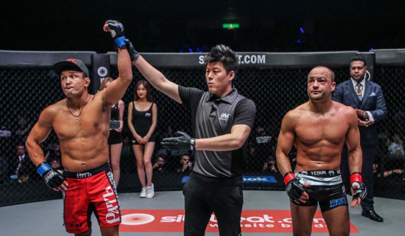 Timofey Nastyukhin (left) gets his hand raised by the official after beating Eddie Alvarez in Japan.