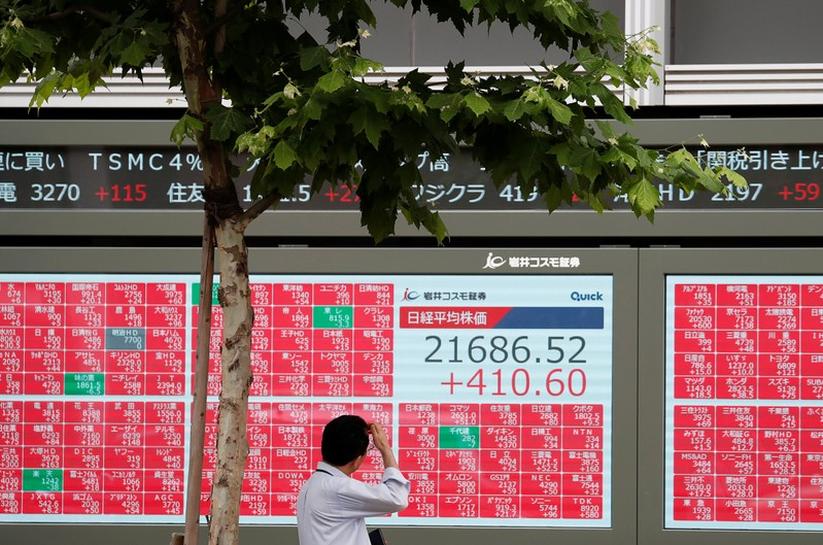 A man looks at a stock quotation board outside a brokerage in Tokyo, Japan, July 1, 2019. REUTERS/Issei Kato/File Photo