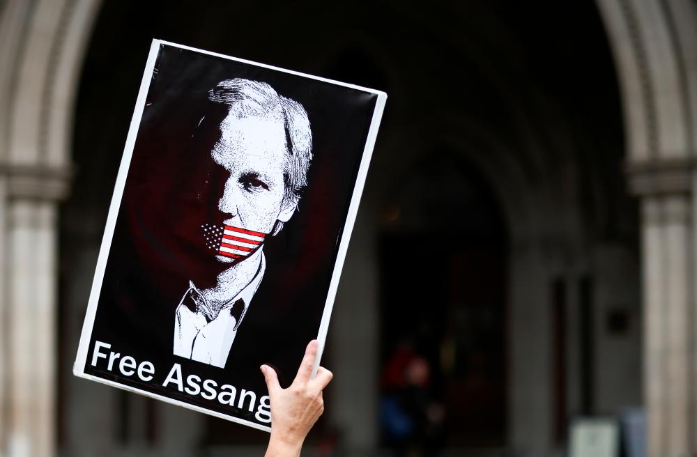 A supporter of Wikileaks founder Julian Assange protests outside the Royal Courts of Justice in London, Britain, October 27, 2021. REUTERSpix