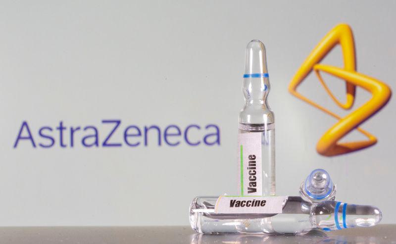 A test tube labeled with the vaccine is seen in front of AstraZeneca logo in this illustration taken, September 9, 2020. — Reuters