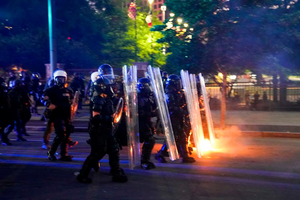 Police officers advance after firing tear gas during a demonstration on May 31, 2020 in Atlanta, Georgia. - AFP