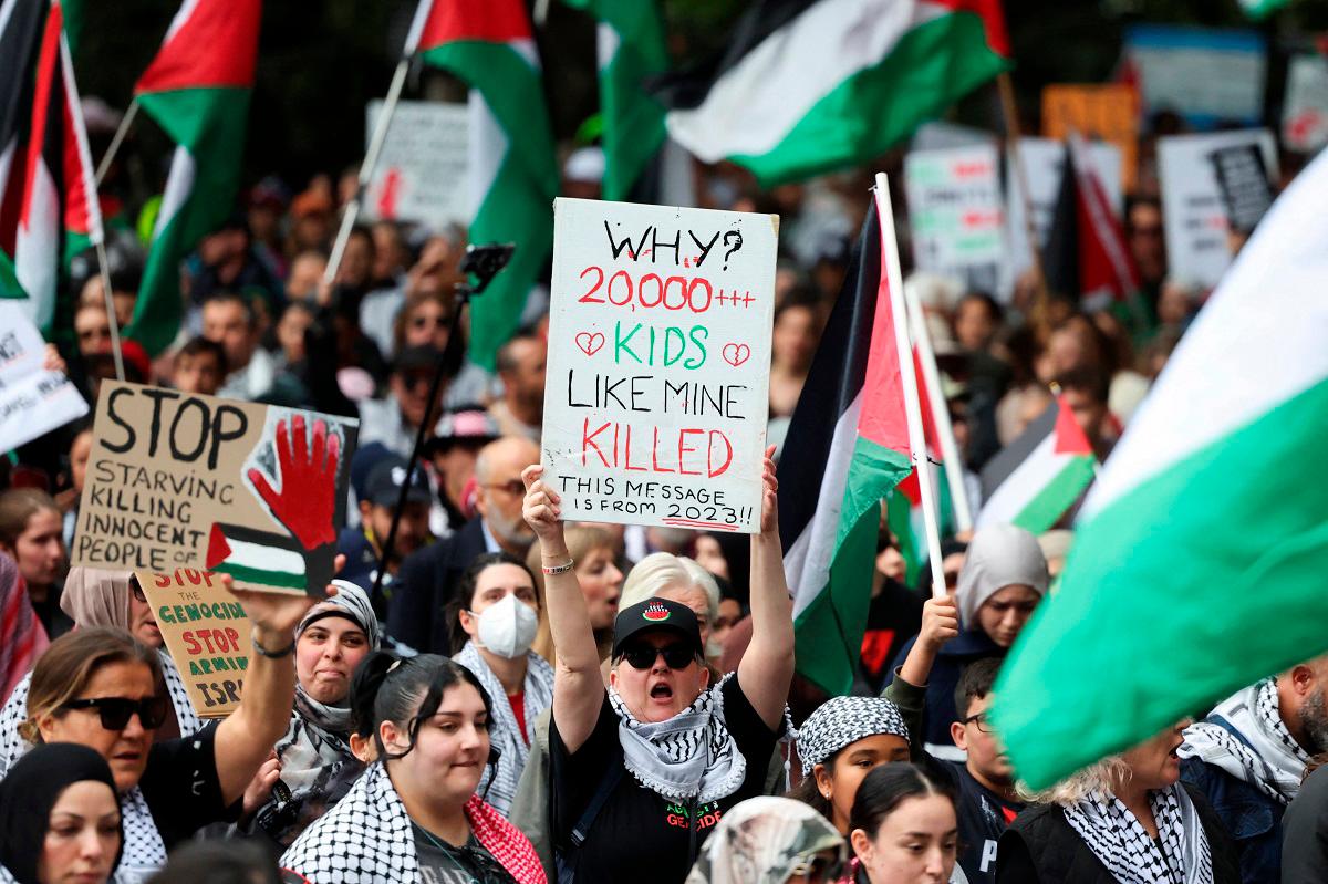 Demonstrators hold placards as they take part in the 'Nationwide March for Palestine' protest in Sydney, Australia, August 24, 2025. - REUTERS/Hollie Adams