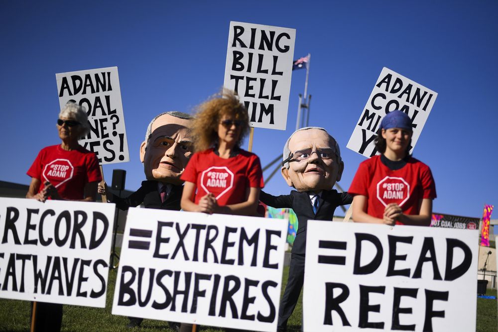 File picture shows protesters wearing giant puppet heads resembling Australian Prime Minister Scott Morrison and Australian Opposition Leader Bill Shorten during a Stop Adani protest outside Parliament House in Canberra, Australia, on Feb 12, 2019. — Reuters