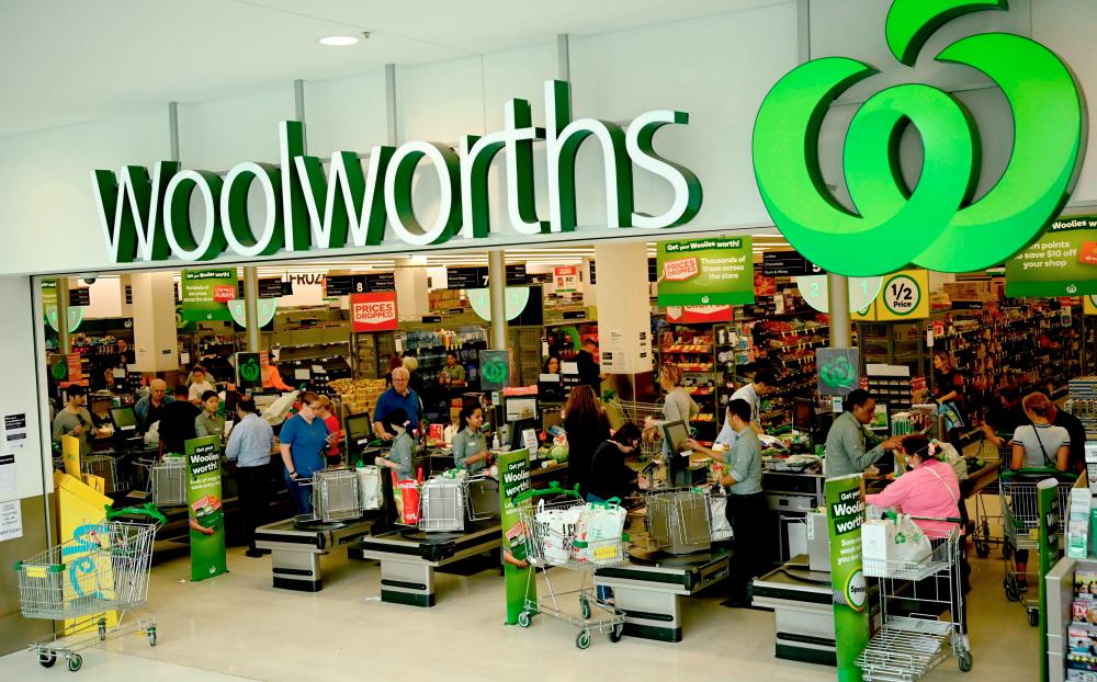 People shop at a Woolworths supermarket in Sydney on March 17, 2020. — AFP