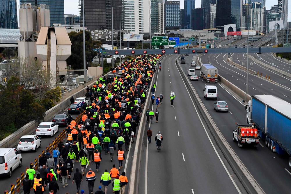 Construction workers and demonstrators attend a protest against Covid-19 regulations in Melbourne on September 21, 2021. AFPpix