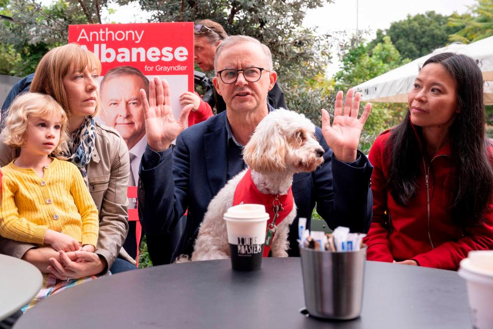 Leader of the Australian Labor Party Anthony Albanese (C) meets with Labor candidate for Reid, Sally Sitou (R) and supporters after winning the general election at Marrickville Library and Pavilion in Sydney on May 22, 2022. AFPPIX