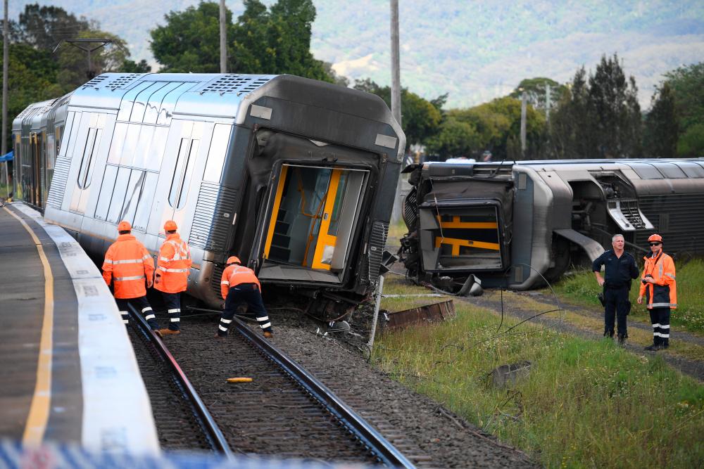 A derailed passenger train is seen after it hit a car on a level crossing in Kembla Grange, Australia, October 20, 2021. AAP Image/Dean Lewins via REUTERSpix