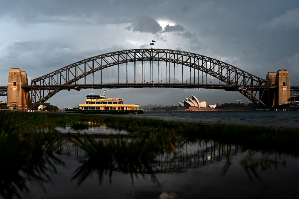 A public ferry makes its way across Sydney Harbour during thundery weather in Sydney on October 14, 2021. AFPpix