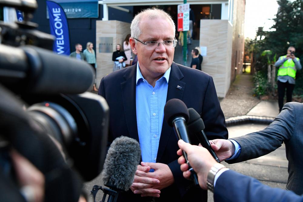 Australian Prime Minister Scott Morrison speaks to the media as he arrives at the Horizon Church in Sutherland in Sydney, Australia, May 19, 2019. - Reuters