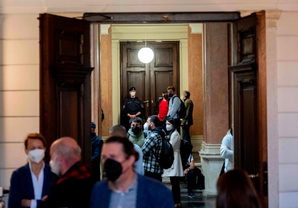 Journalists and members of the public await to enter the court room at the regional court in Vienna, on October 18, 2022. - AFPPIX