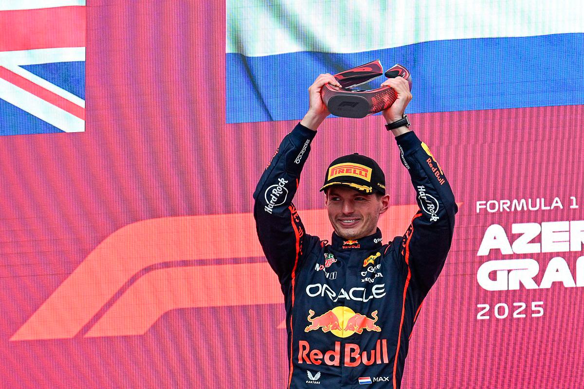 Red Bull Racing’s Dutch driver Max Verstappen celebrates with his trophy on the podium after the Formula One Azerbaijan Grand Prix at the Baku City Circuit in Baku on September 21, 2025. - Ozan KOSE / AFP