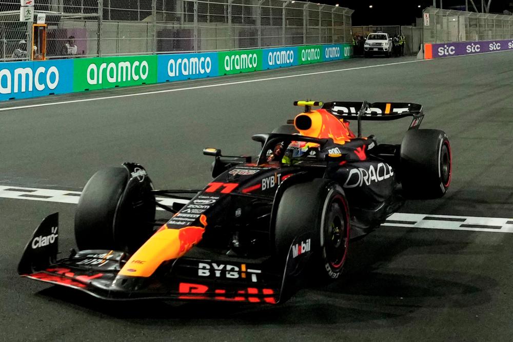 Red Bull Racing driver Sergio Perez crosses the finish line to win the Saudi Arabia Formula One Grand Prix at the Jeddah Corniche Circuit in Jeddah on March 19, 2023. AFPPIX