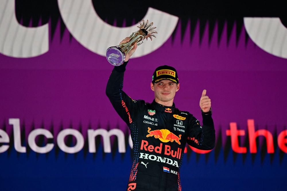 Second-placed Red Bull's Dutch driver Max Verstappen poses with his trophy on the podium after the Formula One Saudi Arabian Grand Prix at the Jeddah Corniche Circuit in Jeddah on December 5, 2021. AFPpix
