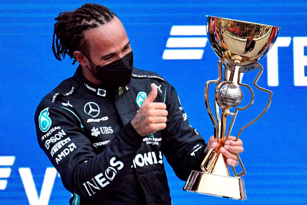 Mercedes’ British driver Lewis Hamilton celebrates after winning the Formula One Russian Grand Prix at the Sochi Autodrom circuit in Sochi on September 26, 2021. AFPpix